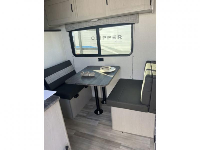 Coachmen RV Clipper Ultra-Lite 17BH travel trailer interior with a dinette with a "gather" sign and plates